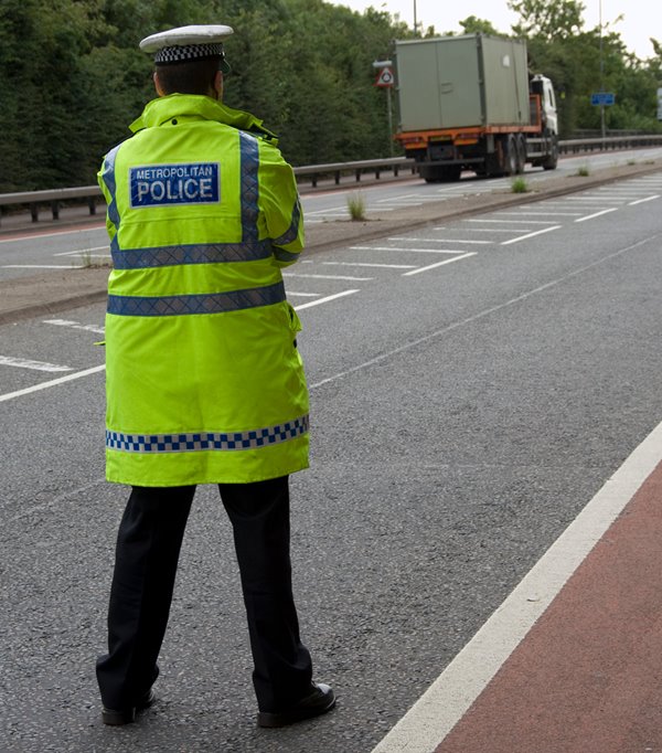 Police watching road as lorry speeds past